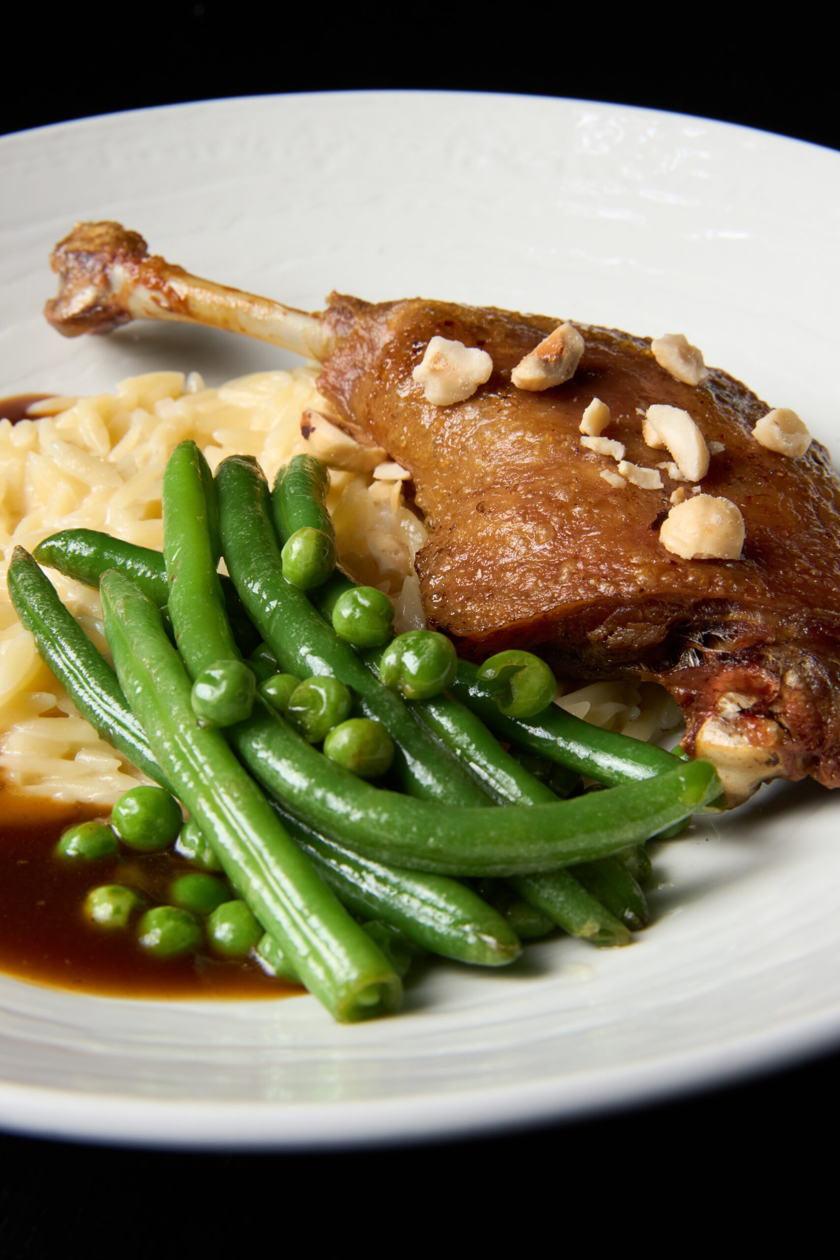 Duck leg with orzo and pak choi
