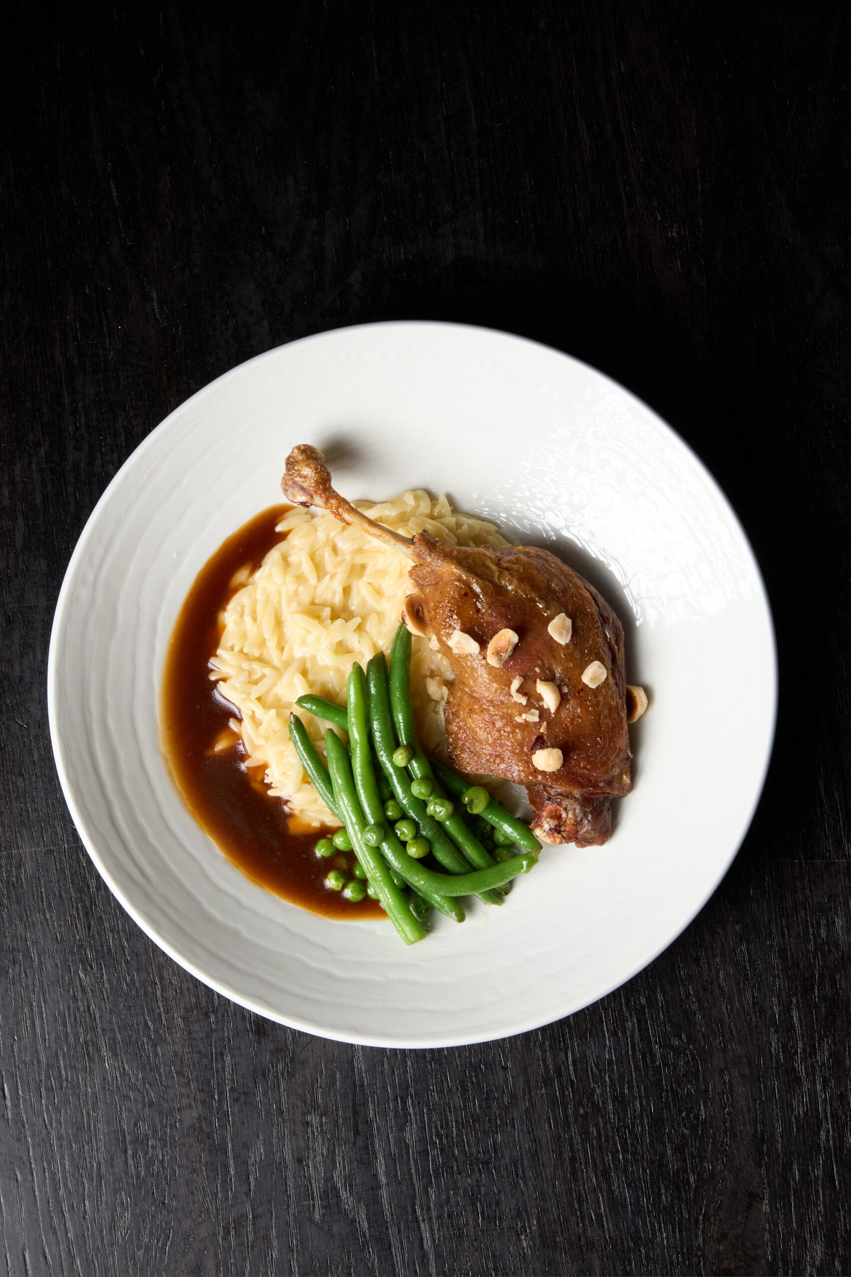 Duck leg with orzo and pak choi