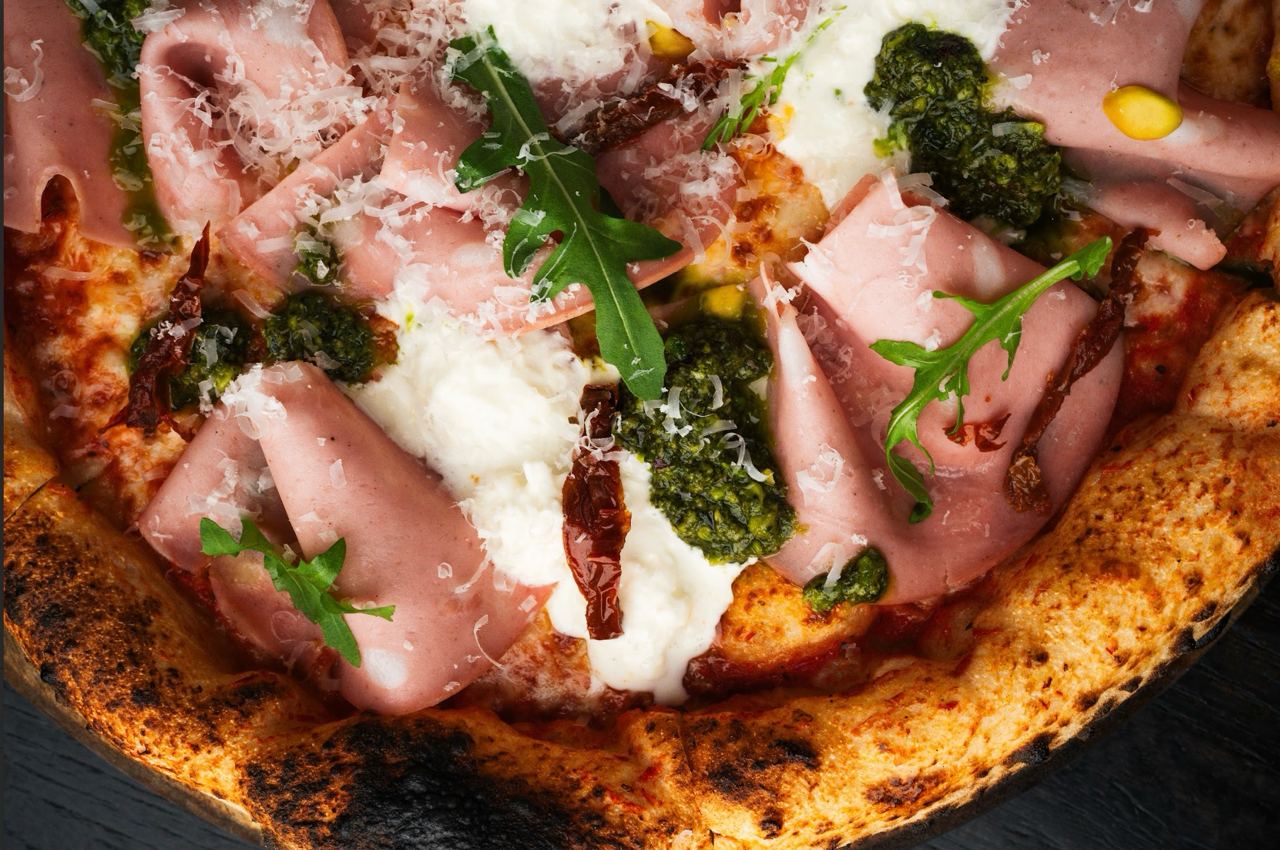 Pizza with mortadella and pesto sauce